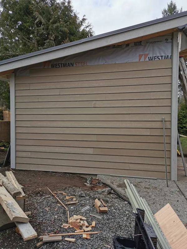New lap siding going onto a garage, over the house wrap