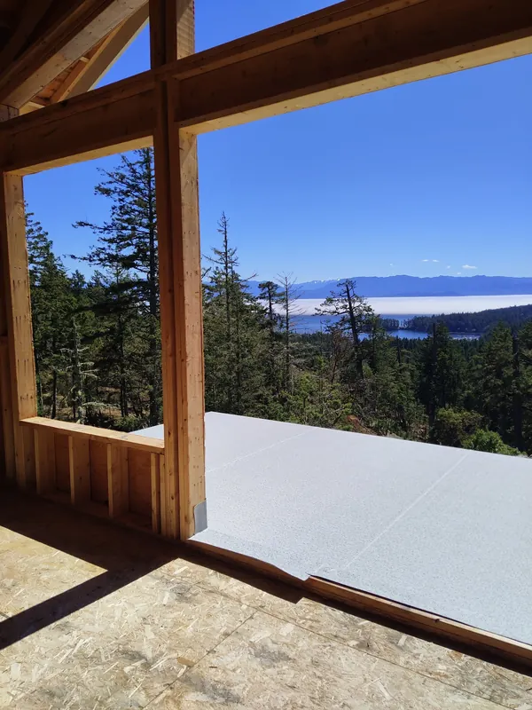 New build timber frame with a vinyl-covered deck and ocean view