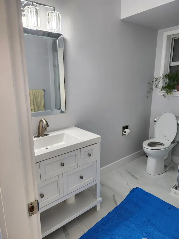 Bathroom with a white vanity and marble-look tile floor