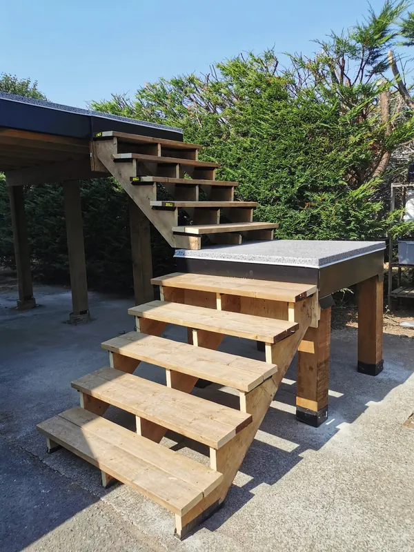 New cedar stairs with a landing leading up to an elevated deck