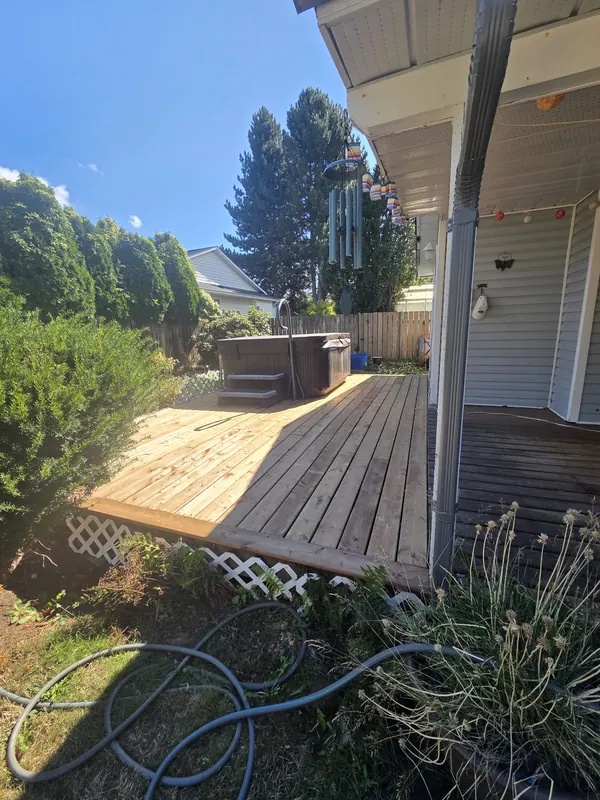 Deck being re-boarded with new light boards next to the old weathered ones