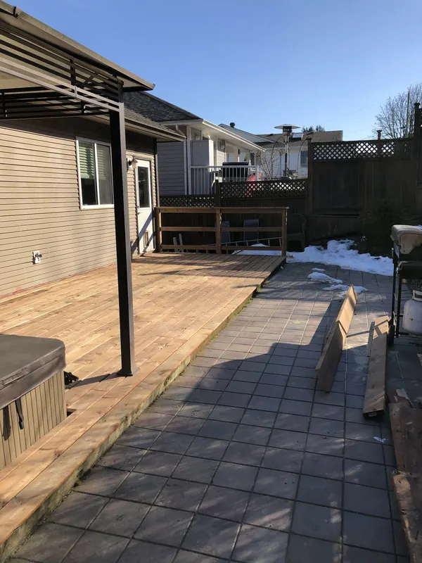 Weathered cedar deck over paving before repair