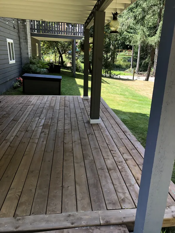 Weathered covered wood deck before repair