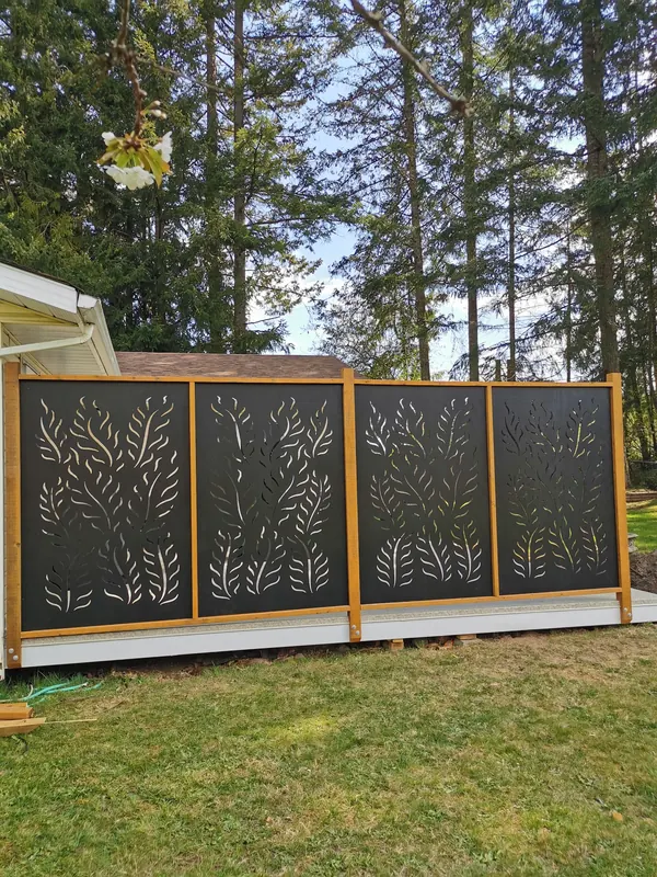 Decorative black privacy screen panels in a cedar frame