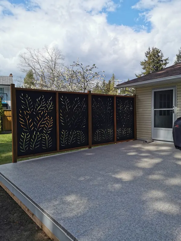 Decorative privacy screen panels beside a speckled patio deck