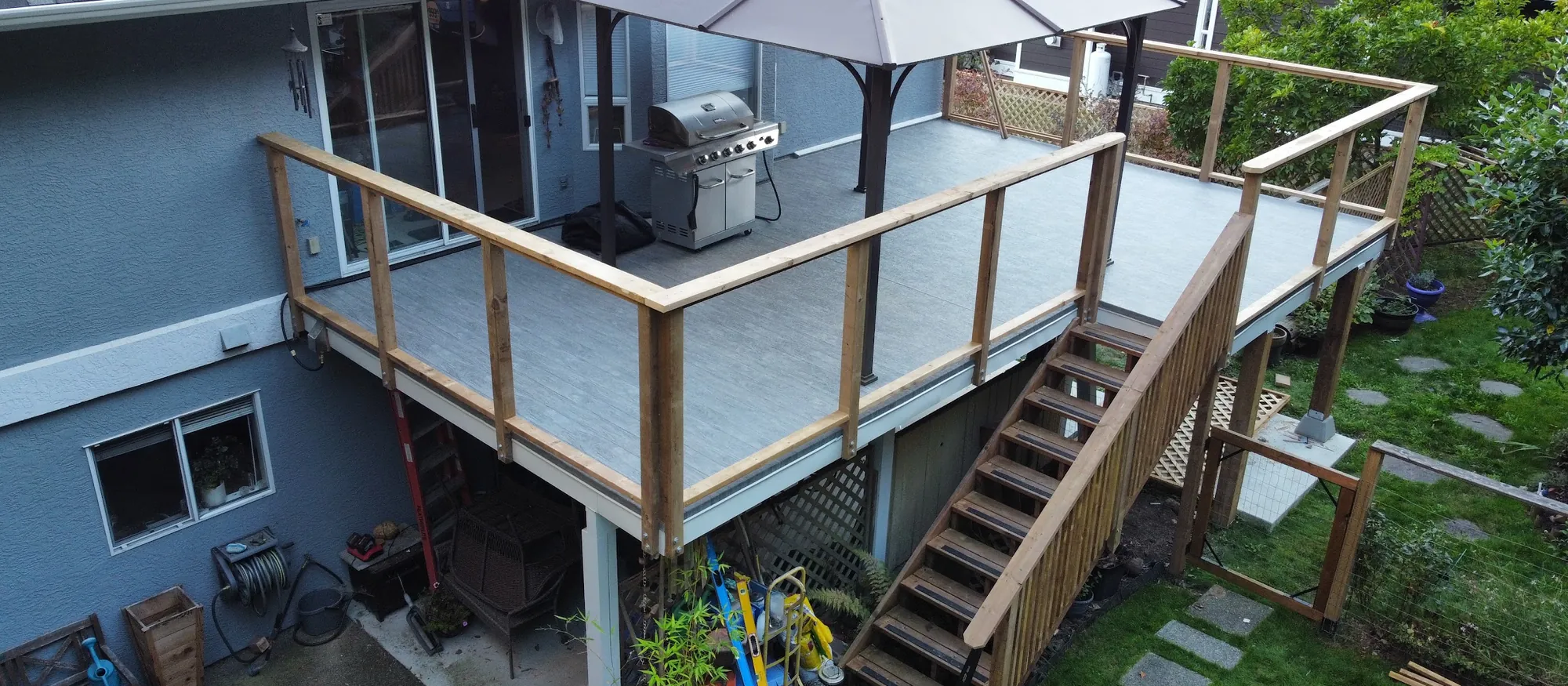 Aerial view of an elevated deck with cedar railing, gazebo and cedar stairs