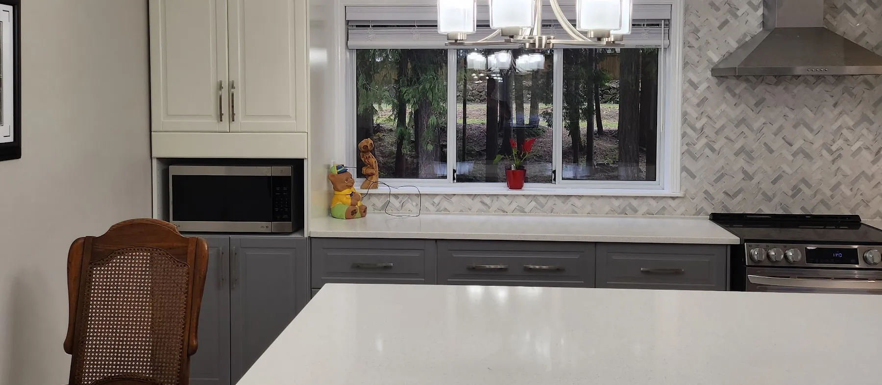 Finished kitchen with a navy island, white cabinets and a large-format tile floor