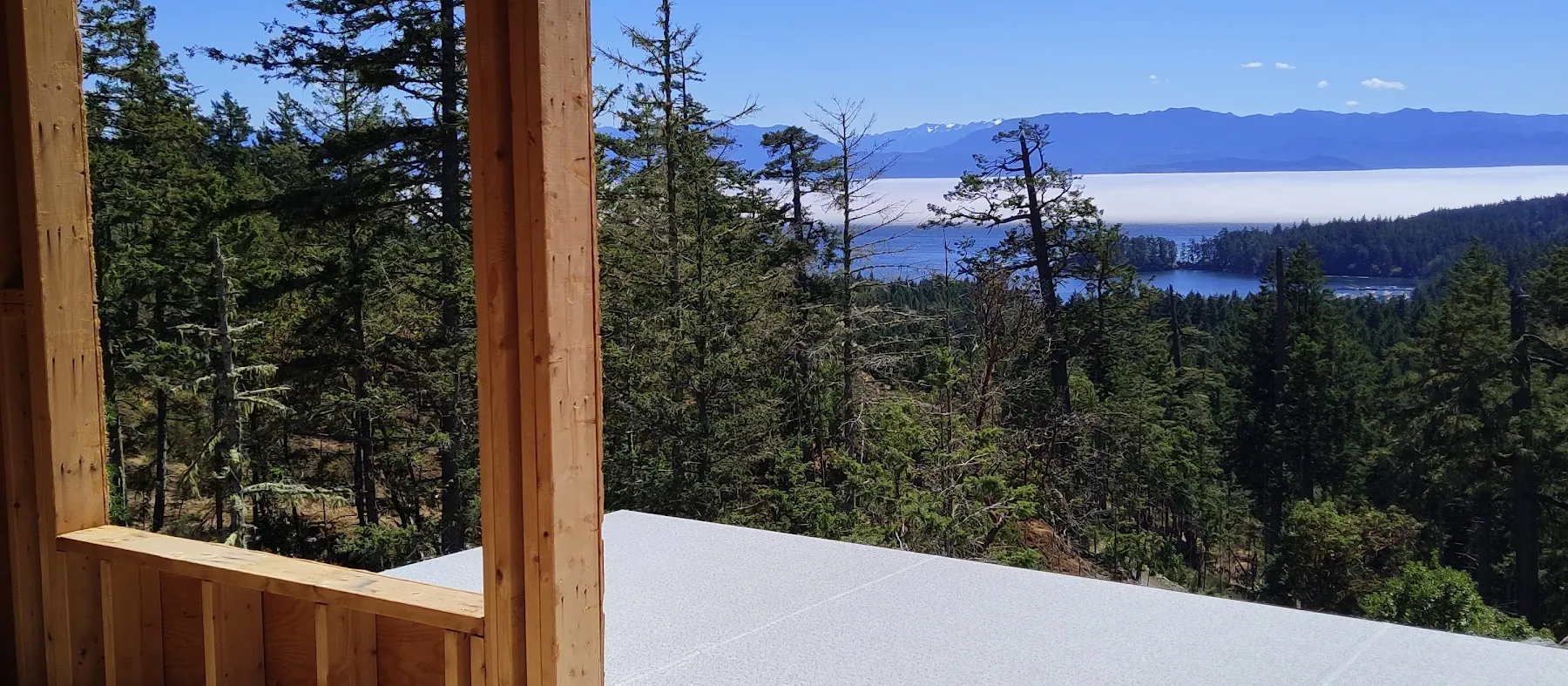 New build timber frame with a vinyl-covered deck and ocean view