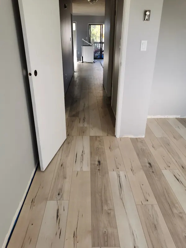 New light plank flooring running down a hallway