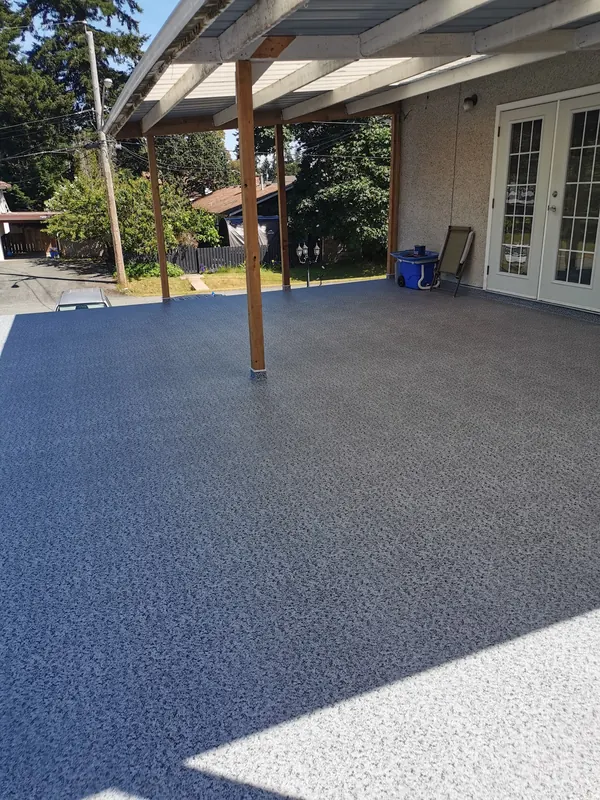 Covered grey speckled vinyl deck with cedar posts outside a pair of french doors