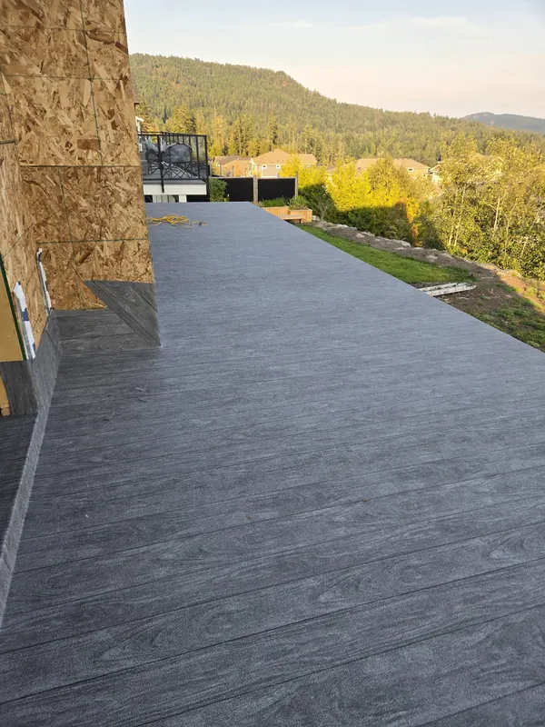 Grey wood-grain vinyl deck with a view across the valley